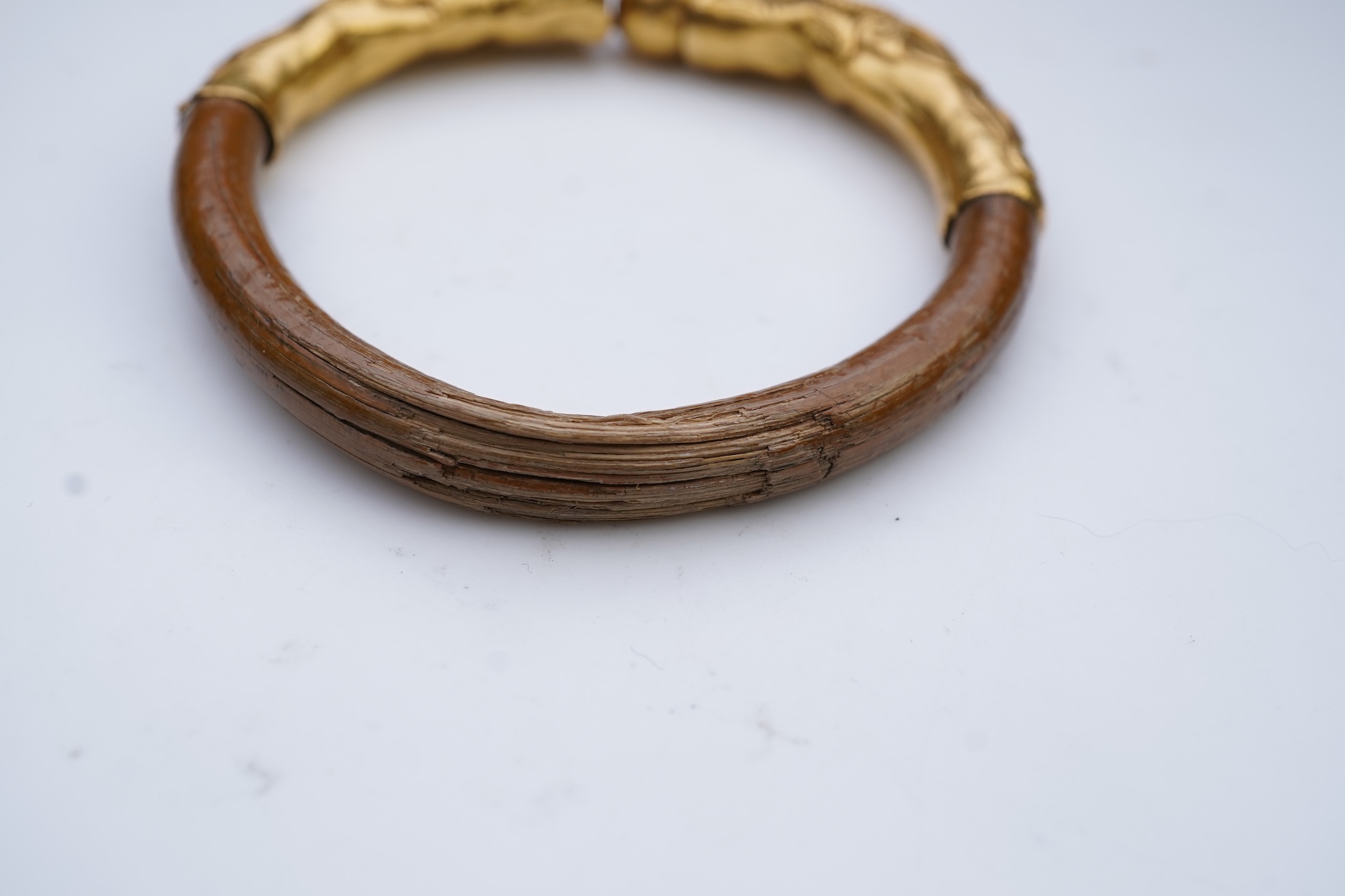 A gold and wood bangle, China, late 19th/early 20th century